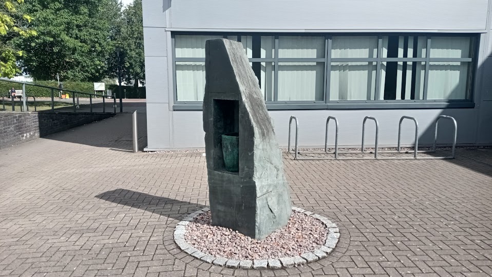 Slate sculpture with bronze 'jug' incorporated into a hollow